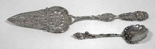 Appraisal: A Continental silvery metal cake slice decorated with fruiting vines