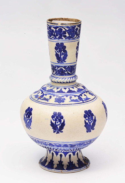 Appraisal: A PERSIAN UNDERGLAZE BLUE BOTTLE VASE with simple flower and