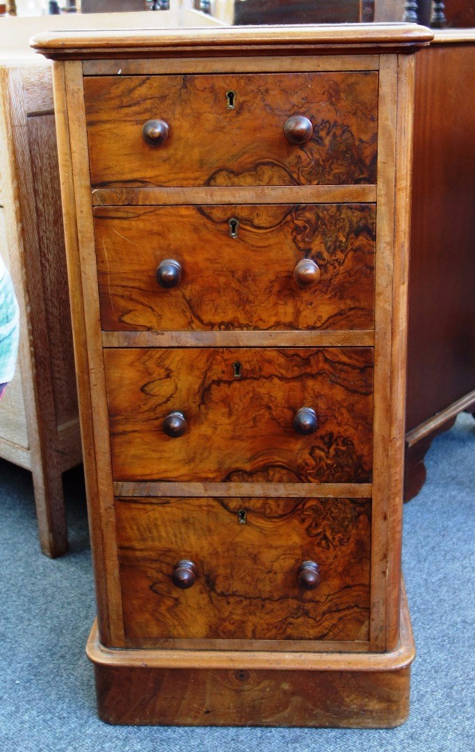 Appraisal: A th century figured walnut four drawer pedestal on plinth