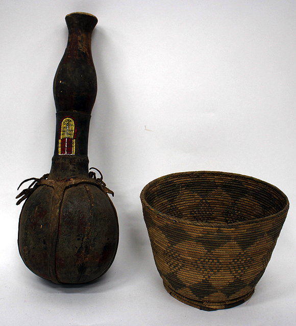 Appraisal: AN AFRICAN TRIBAL LEATHER AND TURNED WOODEN VESSEL with carrying