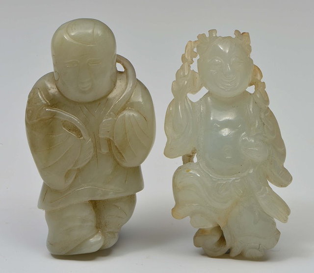 Appraisal: A CHINESE MUTTON FAT JADE PEBBLE carved as a standing