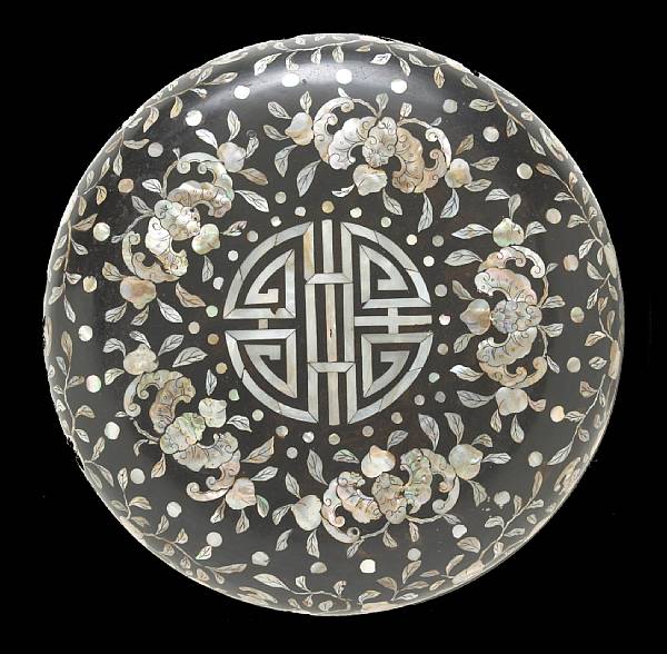 Appraisal: A black lacquer covered circular box with mother-of pearl inlay