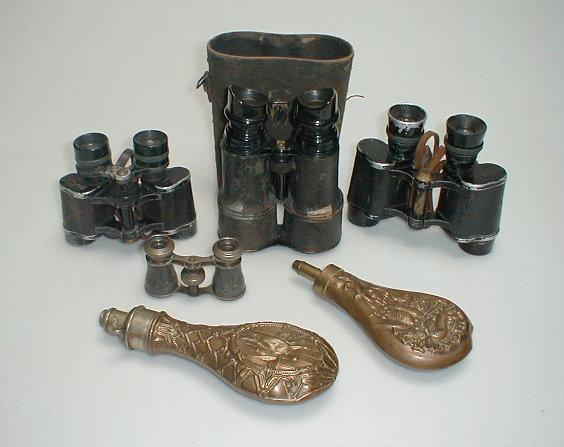 Appraisal: Two embossed powder flasks and various military binoculars