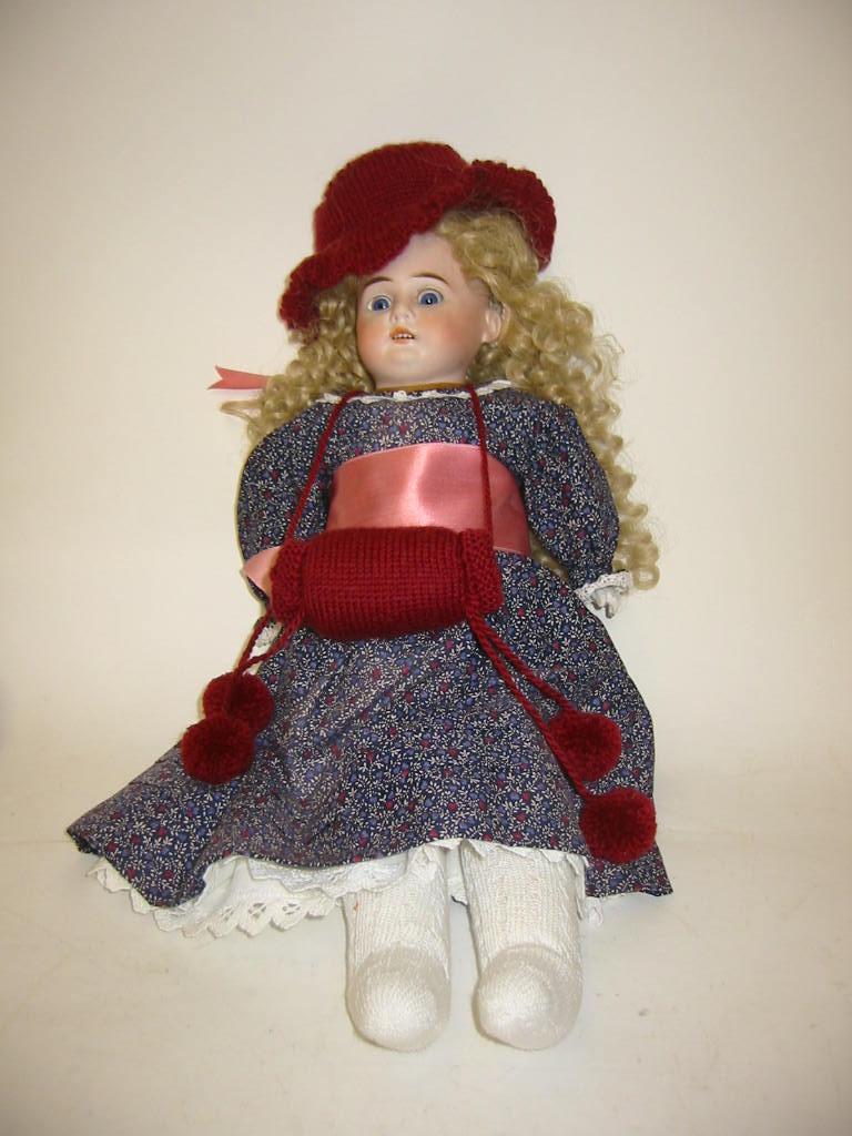 Appraisal: An Armand Marseille bisque shoulder head girl doll with blue