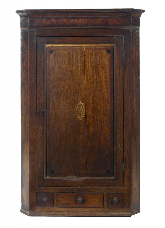 Appraisal: A GEORGE III OAK CORNER CUPBOARD of splay fronted form