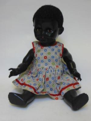 Appraisal: A Pedigree plastic negro girl doll with sleeping eyes wool