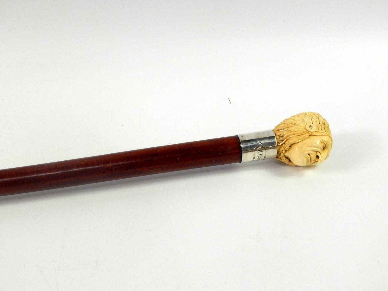 Appraisal: A malacca walking stick with an ivory knop carved as