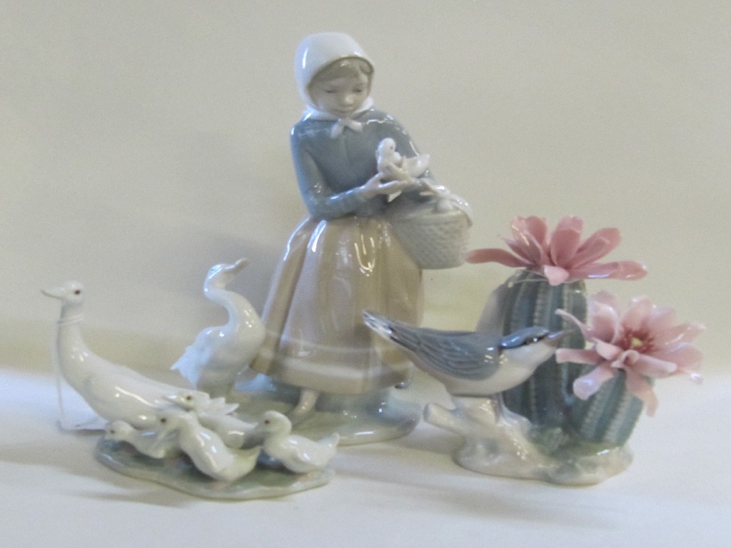 Appraisal: Three Lladro figure groups to include a girl with ducks