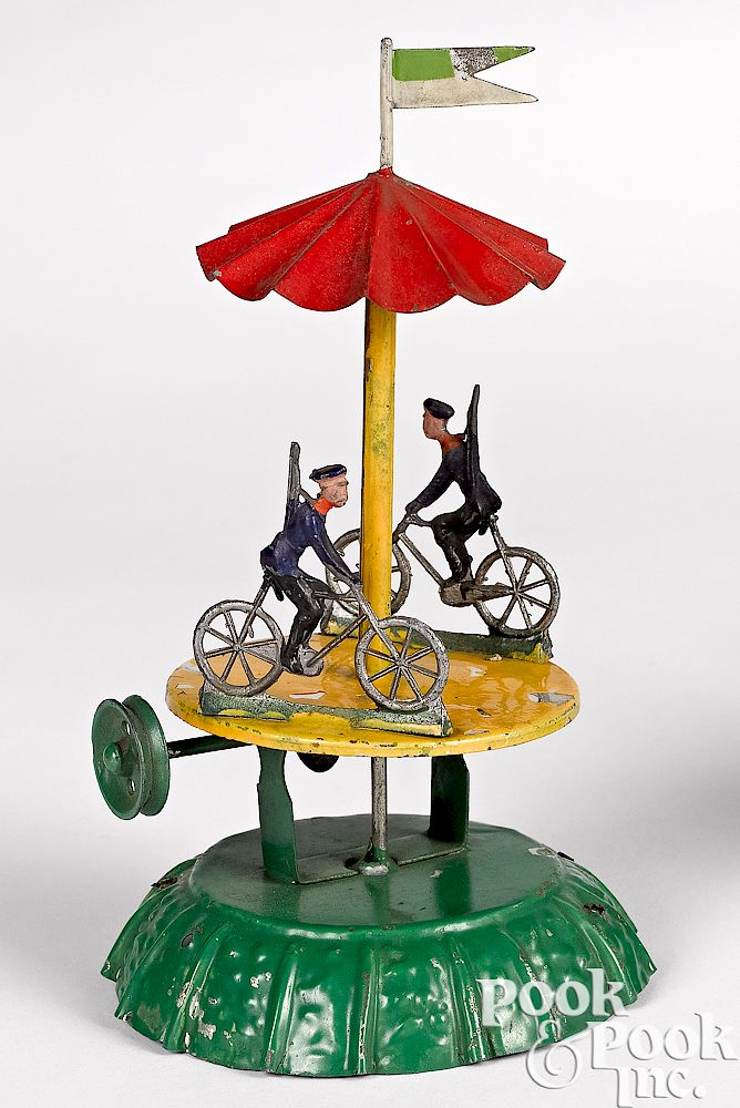 Appraisal: Painted tin cyclist carousel steam toy accessory Painted tin cyclist