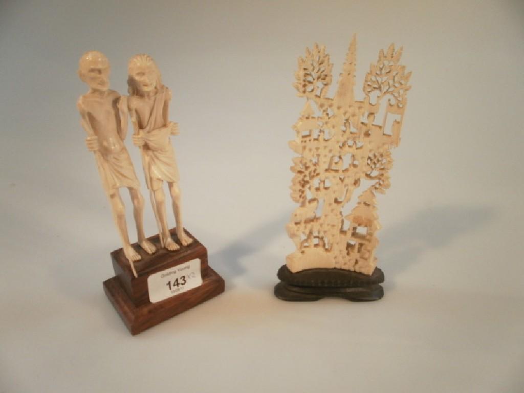 Appraisal: A carved ivory figure of an emaciated man and woman