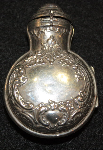 Appraisal: A SILVER SCENT BOTTLE HOLDER of circular form with embossed