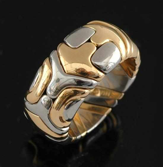 Appraisal: A gold ring by Bvlgari The expandable wide band comprised