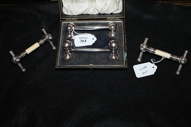 Appraisal: A CASED PAIR OF VICTORIAN SILVER PLATED KNIFE RESTS together