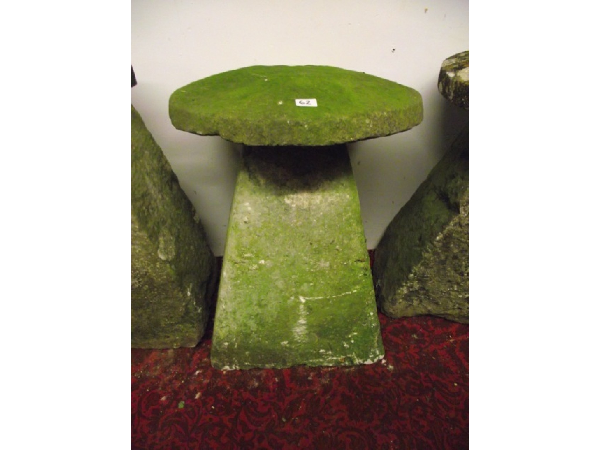 Appraisal: A natural stone staddle stone with tapered base and domed