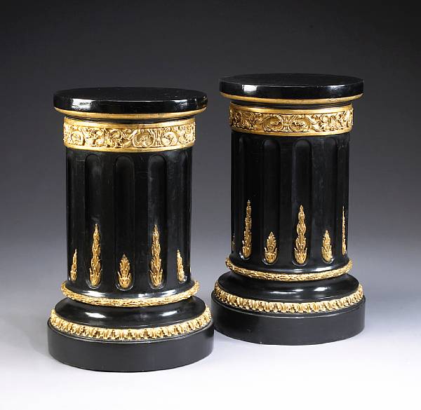 Appraisal: A pair of Neoclassical style parcel gilt and ebonized columnar