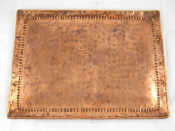 Appraisal: A Newlyn copper tray with punched upturned border and rolled