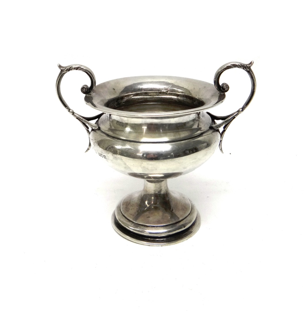 Appraisal: A silver twin handled trophy cup with a circular foot