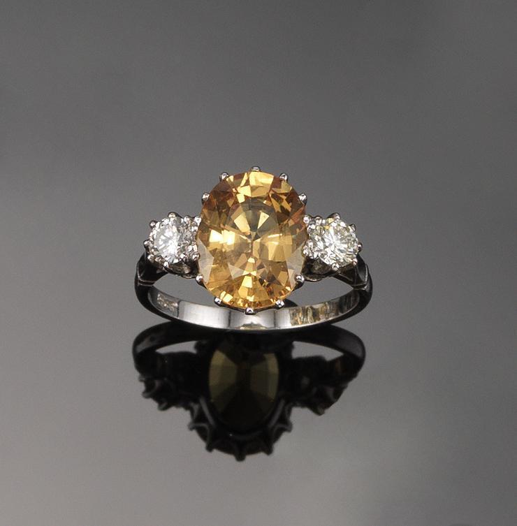 Appraisal: A yellow sapphire and diamond three stone ring