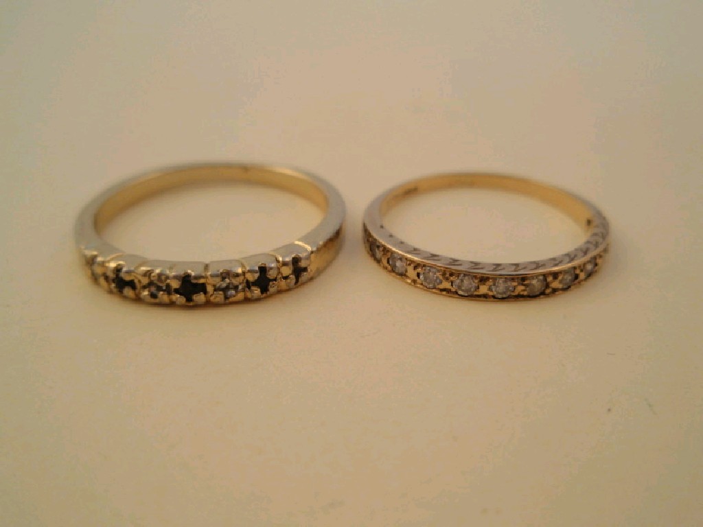 Appraisal: Two stone set half hoop eternity rings