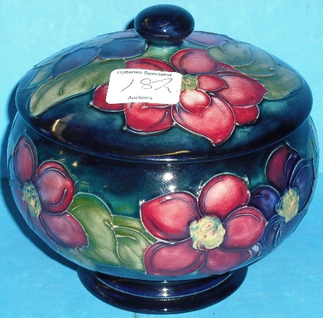 Appraisal: Moorcroft unusual footed round bowl cover decorated in the Clematis