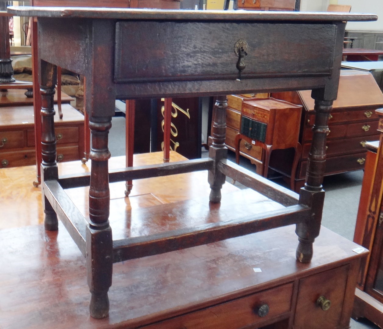 Appraisal: A th century oak single drawer side table on turned