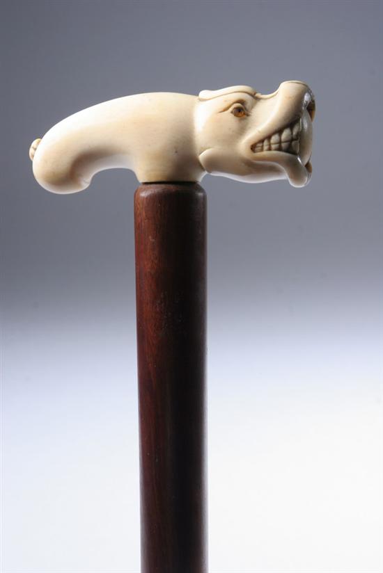 Appraisal: HIPPOPOTAMUS CANE Carved in ivory hippo with glass eyes and