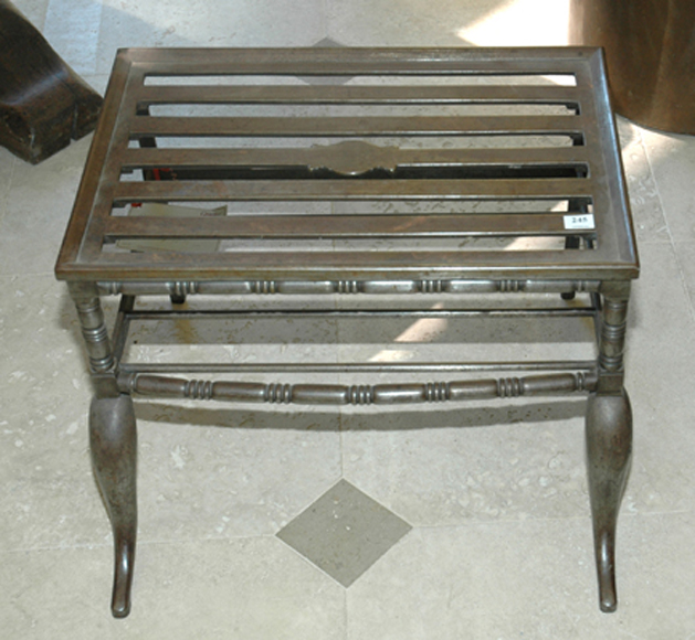 Appraisal: A RARE GEORGE III STEEL TRIVET The rectangular slatted top