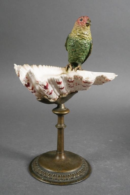 Appraisal: Cold painted bronze parakeet or parrot perched on shell attached