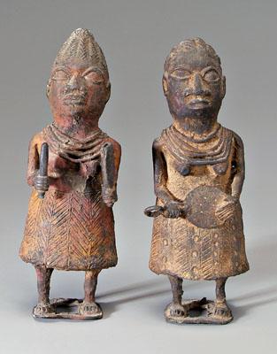 Appraisal: Two African brass female figures each holding implement old red