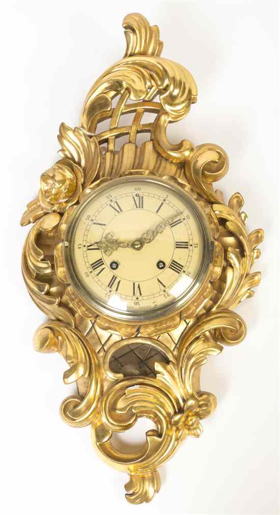 Appraisal: A Swedish Giltwood Cartel Clock the circular painted dial with