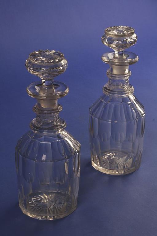 Appraisal: A PAIR OF LATE REGENCY CUT-GLASS DECANTERS with flat-topped stoppers