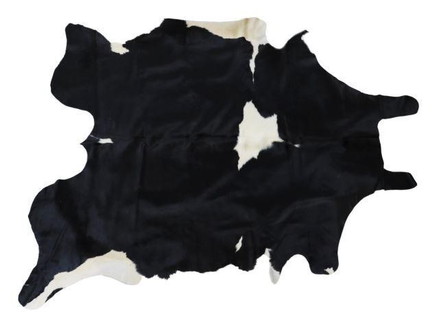 Appraisal: Black and white cowhide with cattle brand largest measurements approx