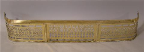 Appraisal: GOTHIC REVIVAL PIERCED BRASS FENDER h w d in