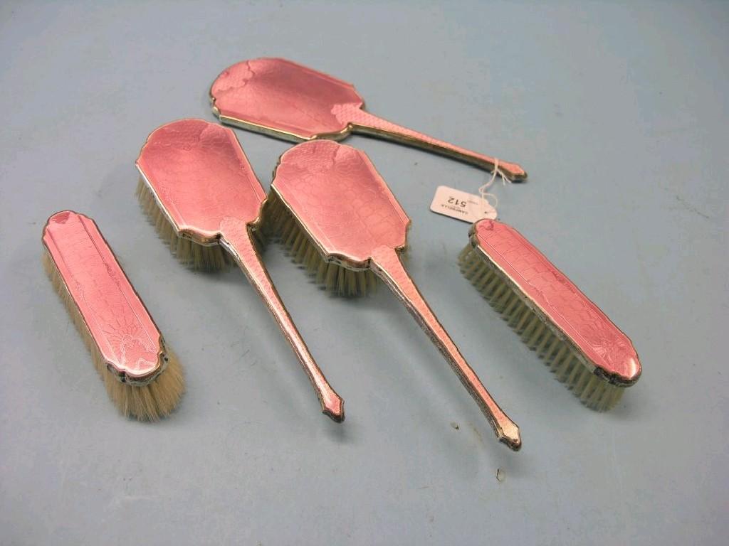 Appraisal: A silver and translucent pink enamel dressing table set five