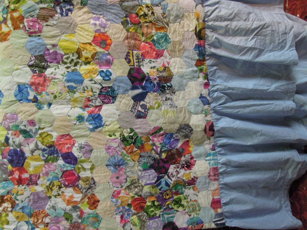 Appraisal: A patchwork quilt with pale blue trimming