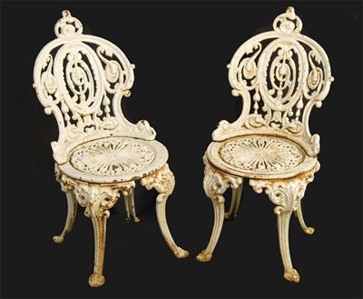 Appraisal: A pair of cast iron garden chairs after a design