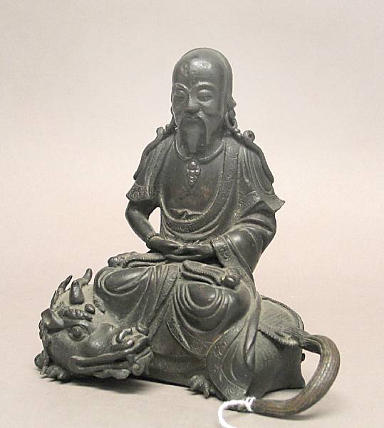 Appraisal: A cast bronze seated figure of a luohan on a