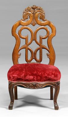 Appraisal: Rococo revival slipper chair laminated rosewood floral crest and pierced