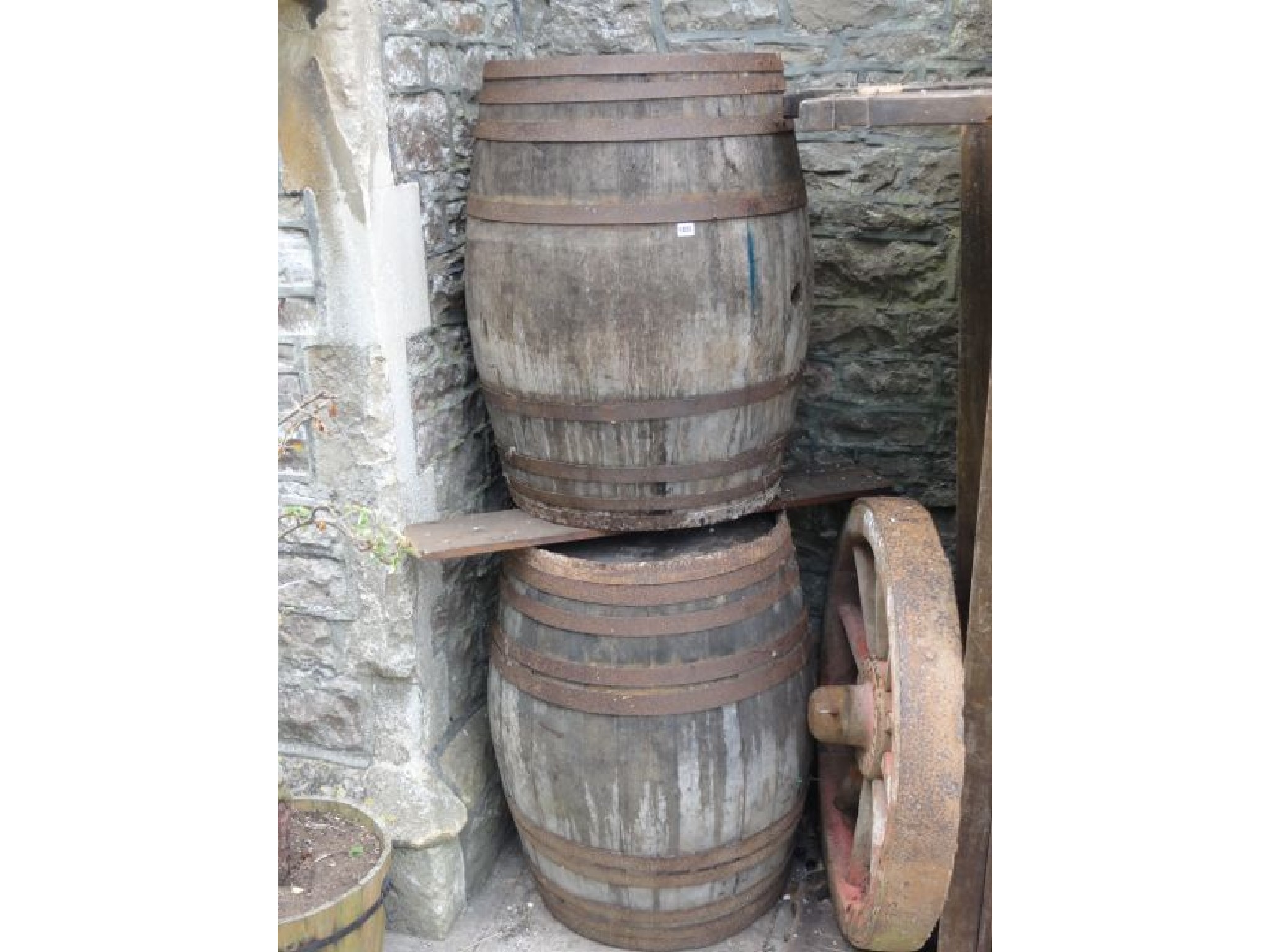 Appraisal: Two large coopered oak and steel banded barrels