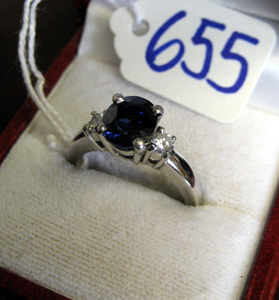 Appraisal: BLUE SAPPHIRE DIAMOND AND PLATINUM RING the four-prong setting centering