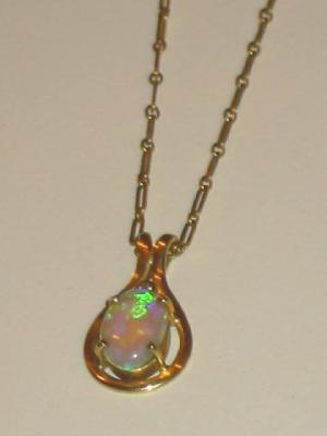 Appraisal: AN OPAL AND DIAMOND PENDANT the oval opal claw set