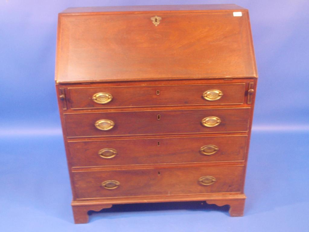 Appraisal: A George III mahogany bureau with fall flap resting on