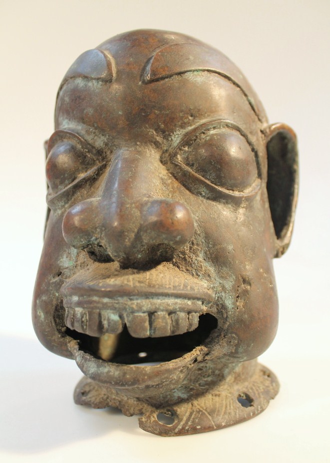 Appraisal: An African tribal bronzed figure head with enhanced features with