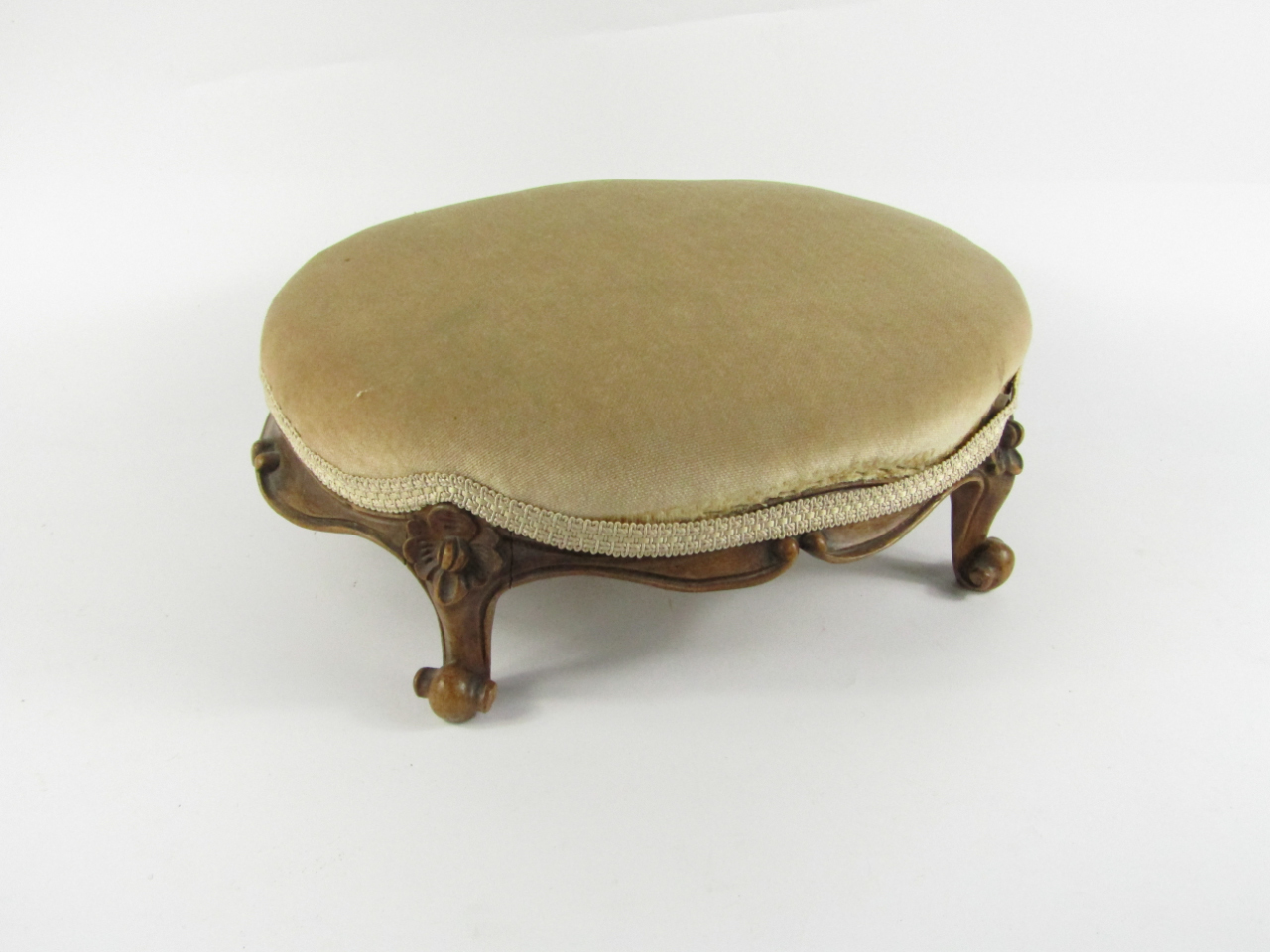 Appraisal: A Victorian walnut oval foot stool with carved floral and