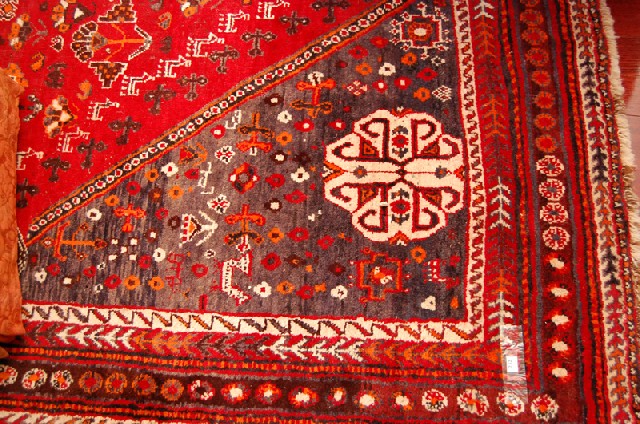 Appraisal: A PERSIAN FLOOR RUG The geometric pattern on a red