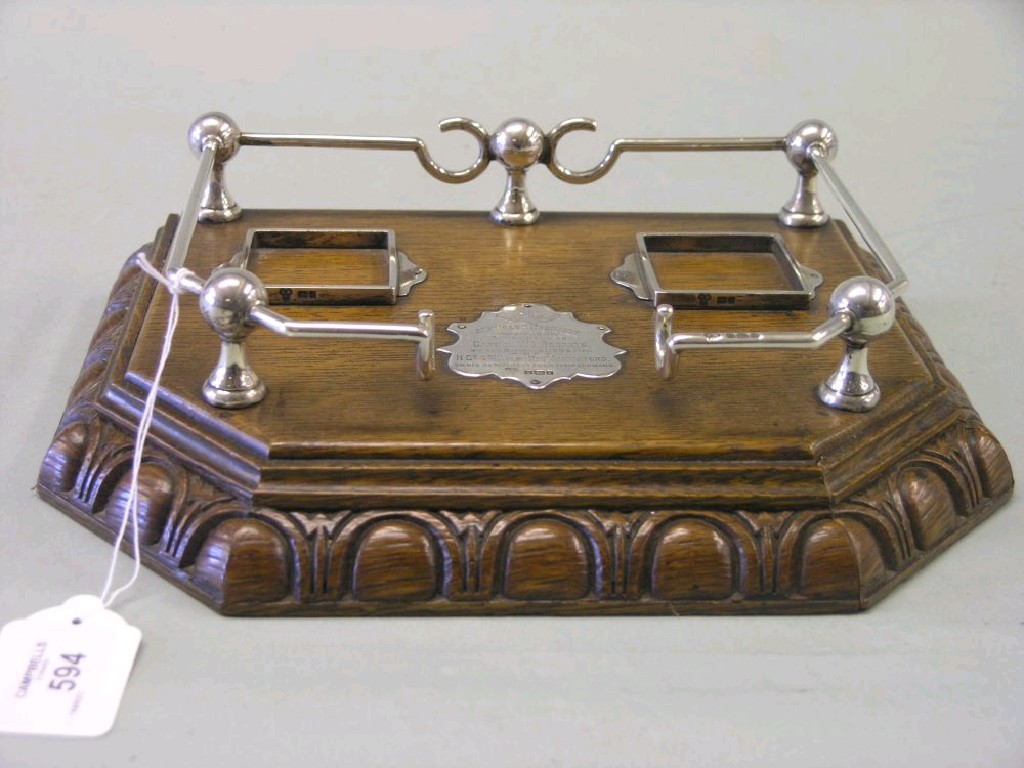 Appraisal: An oak and silver mounted desk stand IV Welsh Regiment