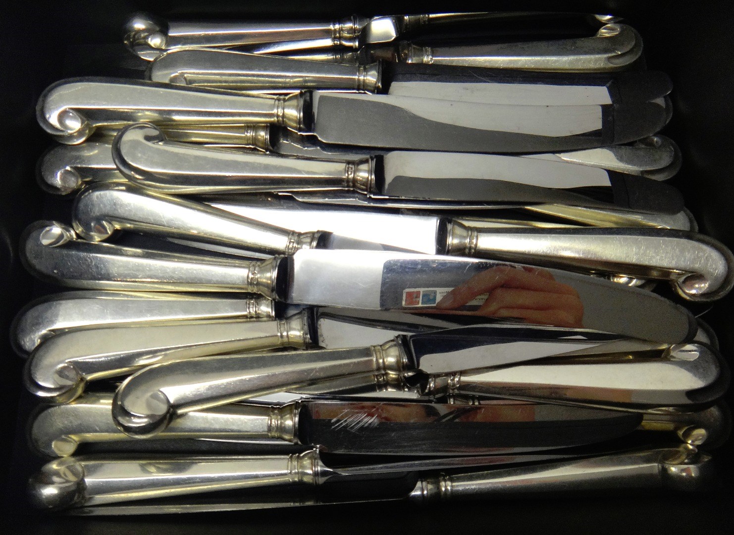 Appraisal: Twelve steel bladed table knives with loaded silver pistol grip