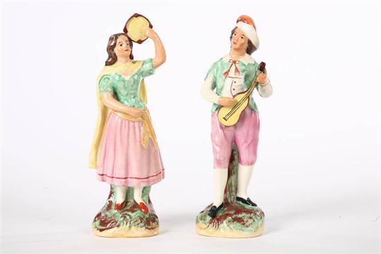 Appraisal: TWO STAFFORDSHIRE FIGURES A man and woman playing instruments h