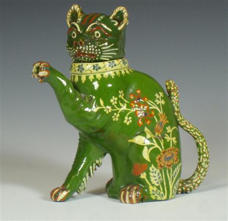 Appraisal: A green painted faience cat creamer Signed Thun the removable