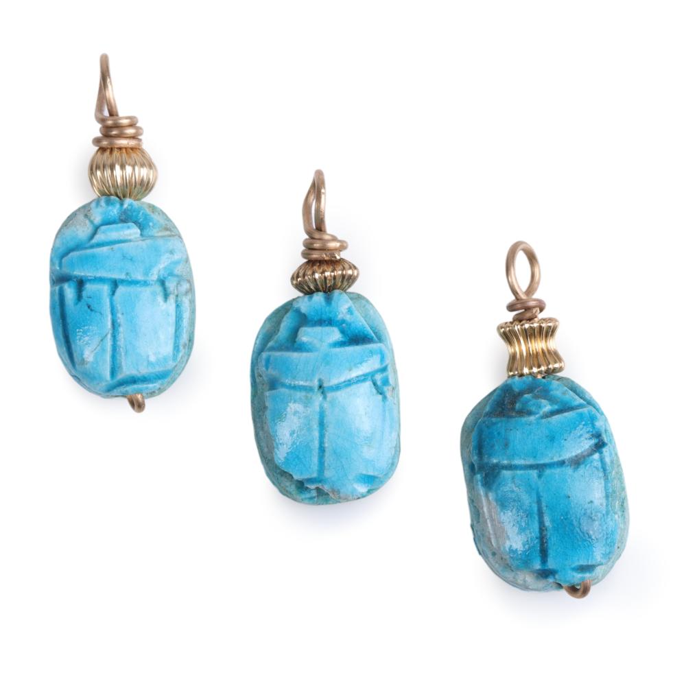 Appraisal: Three Egyptian carved faience turquoise scarab relic pendants with gold